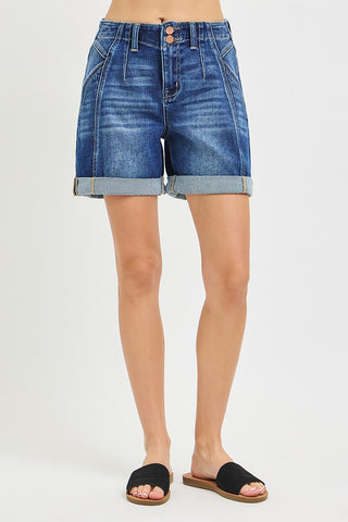 Blue denim shorts worn by a person on a light gray background