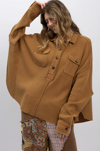 Person wearing a brown jacket with a white background