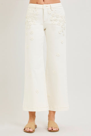 White lace pants worn by a person on a plain background