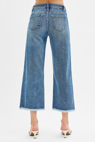 Blue jeans worn by a person on a white background