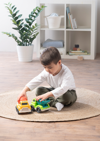 boy playing with toy trucks.
