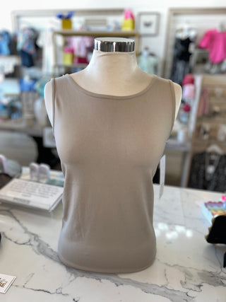 Beige tank top on a mannequin torso in a store setting