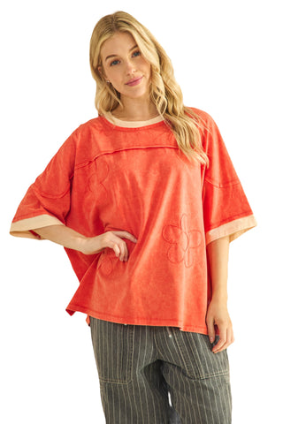 Woman wearing a red oversized shirt with a white background