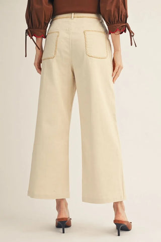 Beige wide-leg pants worn by a person on a plain background