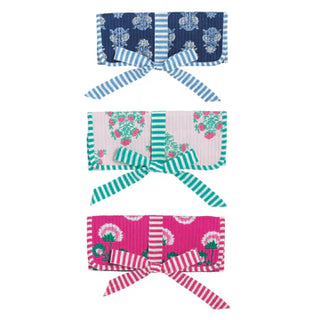 Set of three colorful headbands with floral and striped patterns on a white background