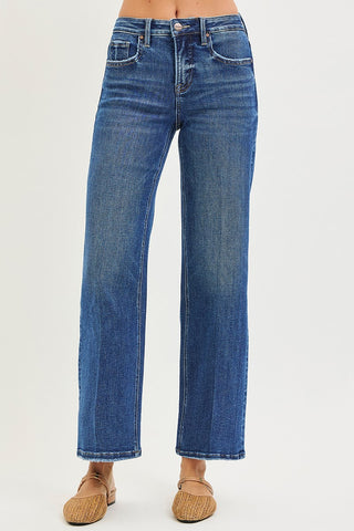 Blue jeans worn by a person on a white background