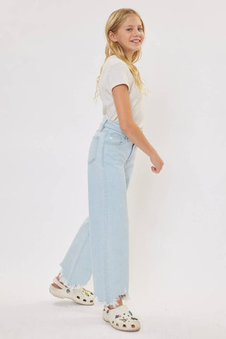 Person wearing a white t-shirt and light blue jeans on a white background