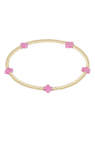 gold bracelet with pink cross beads