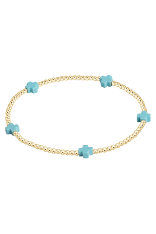 gold bracelet with turquoise cross beads