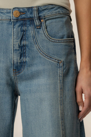 Close-up of blue jeans with a neutral background