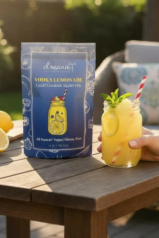 Person holding a vodka lemonade with a scenic background