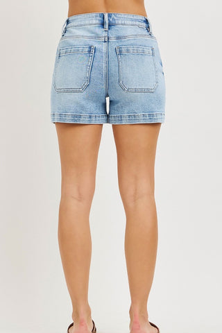 Light blue denim shorts worn by a person on a white background