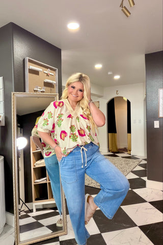 Woman posing in a store with checkered floor and mirrors.