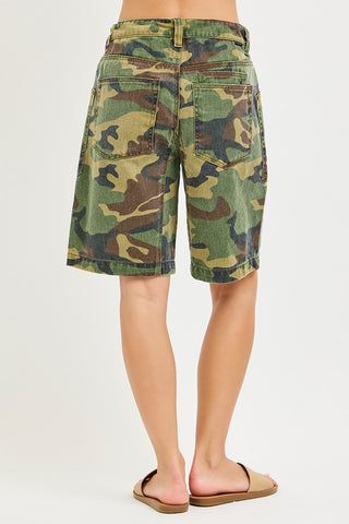 Camouflage shorts worn by a person on a white background
