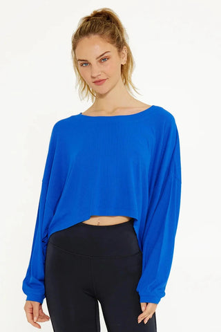 A women wearing a blue cream yoga crop top