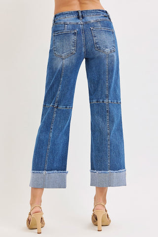 Blue jeans with a patchwork design on a white background