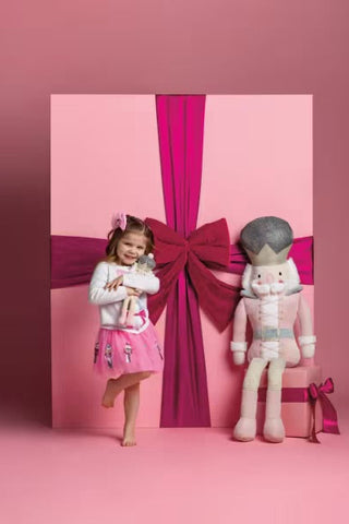 Girl standing with warped present.