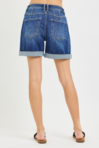 Blue denim shorts worn by a person on a white background