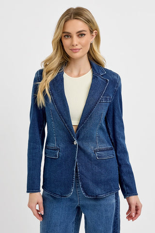 Woman wearing a blue denim blazer on a white background