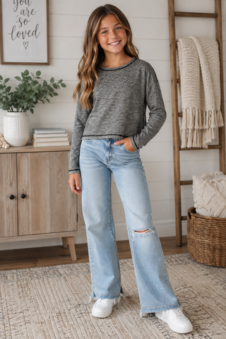 A tween in a mesh cropped activewear top 