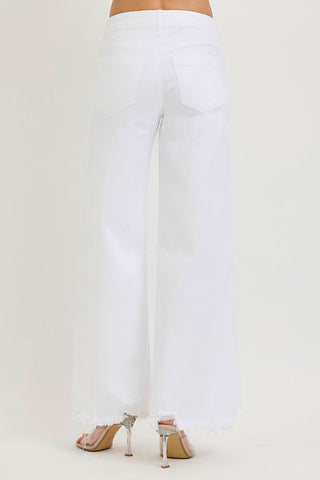 White pants worn with high-heeled shoes on a white background