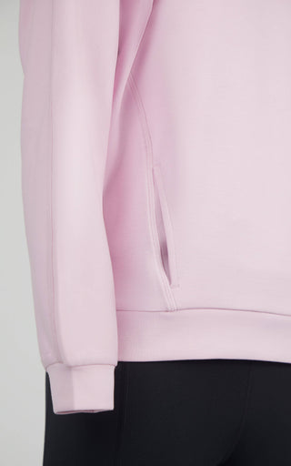 Close-up of a light pink sweatshirt sleeve on a plain background