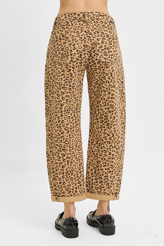 Leopard print pants worn by a person on a white background