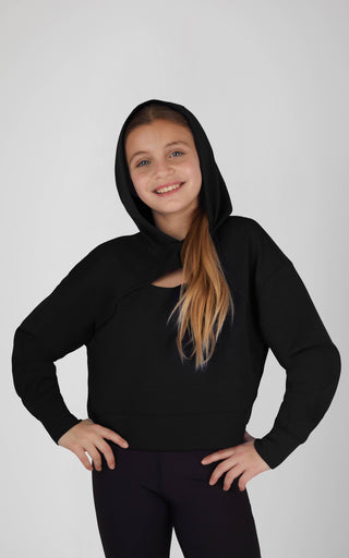 Person wearing a black hoodie on a plain background