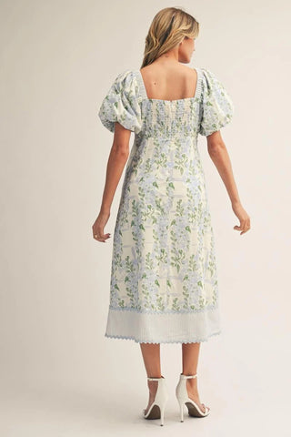 Woman wearing a floral dress on a plain background