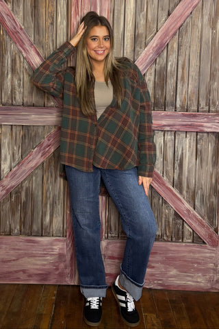 Person standing in front of a wooden gate with a checkered pattern in the background
