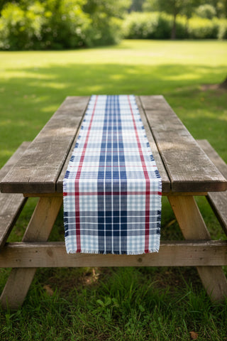Plaid table runner with red, white, and blue pattern on a plain background