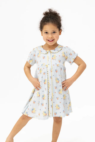 Young girl wearing a floral dress on a white background