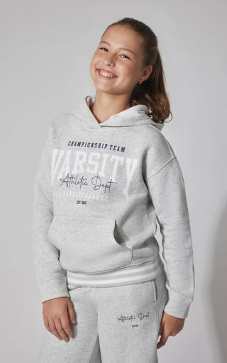 Young girl wearing a gray hoodie and pants with 'Athletic Dept' text on a light gray background