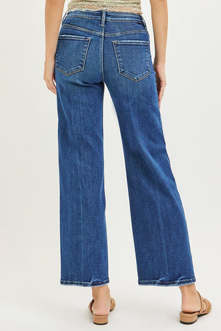Blue jeans worn by a person on a white background