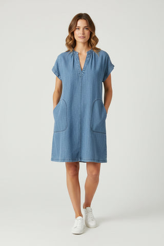 Woman wearing a blue dress on a white background