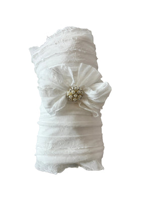 White lace garter with a decorative element on a marble surface
