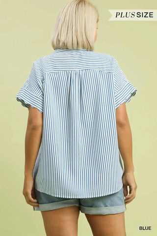 Woman wearing a blue and white striped shirt and shorts on a beige background