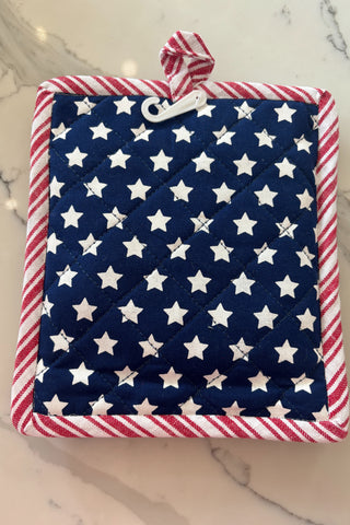 Quilted potholder with American flag pattern on a marble surface