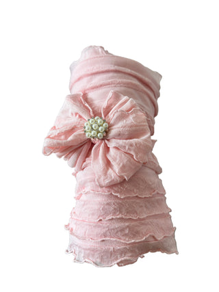 Pink headband with a flower on a marble surface