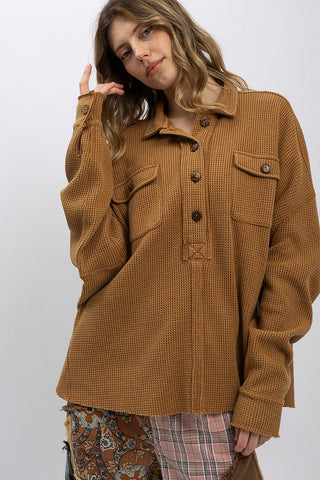 Woman wearing a brown jacket with a white background