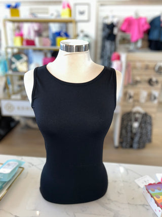 Black tank top on a mannequin in a store setting