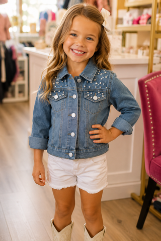 Little girl wearing denim jacket.
