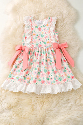 Floral dress with pink bows on a fluffy white surface