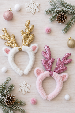 Pink and white fur headband with antlers.