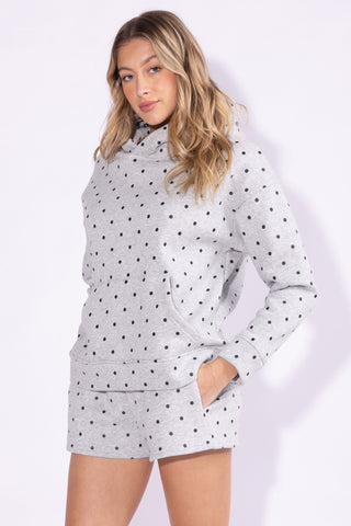 Woman wearing a polka dot dress with a white background