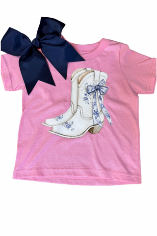 Pink t-shirt with white cowboy boots and blue bows on a white background