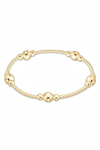 Gold beaded bracelet on a white background