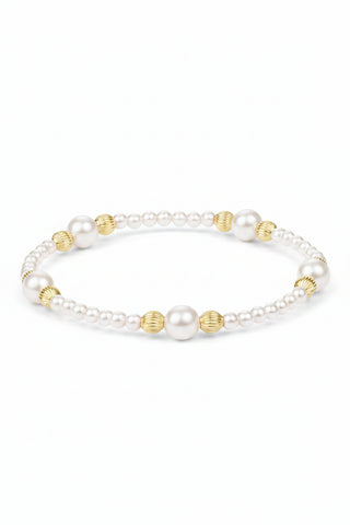Pearl bracelet with gold accents on a white background