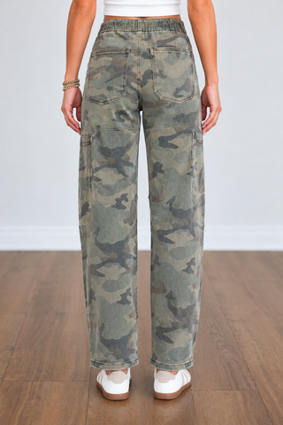 Back view of Zaylen Risen camouflage jeans featuring a gathered elastic waistband, two back patch pockets, paneled seam detailing, and relaxed ankle-length barrel legs.
