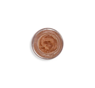 A small clear round cosmetic pot filled with a textured, shimmering warm brown cosmetic product, photographed from directly above on a plain white background.